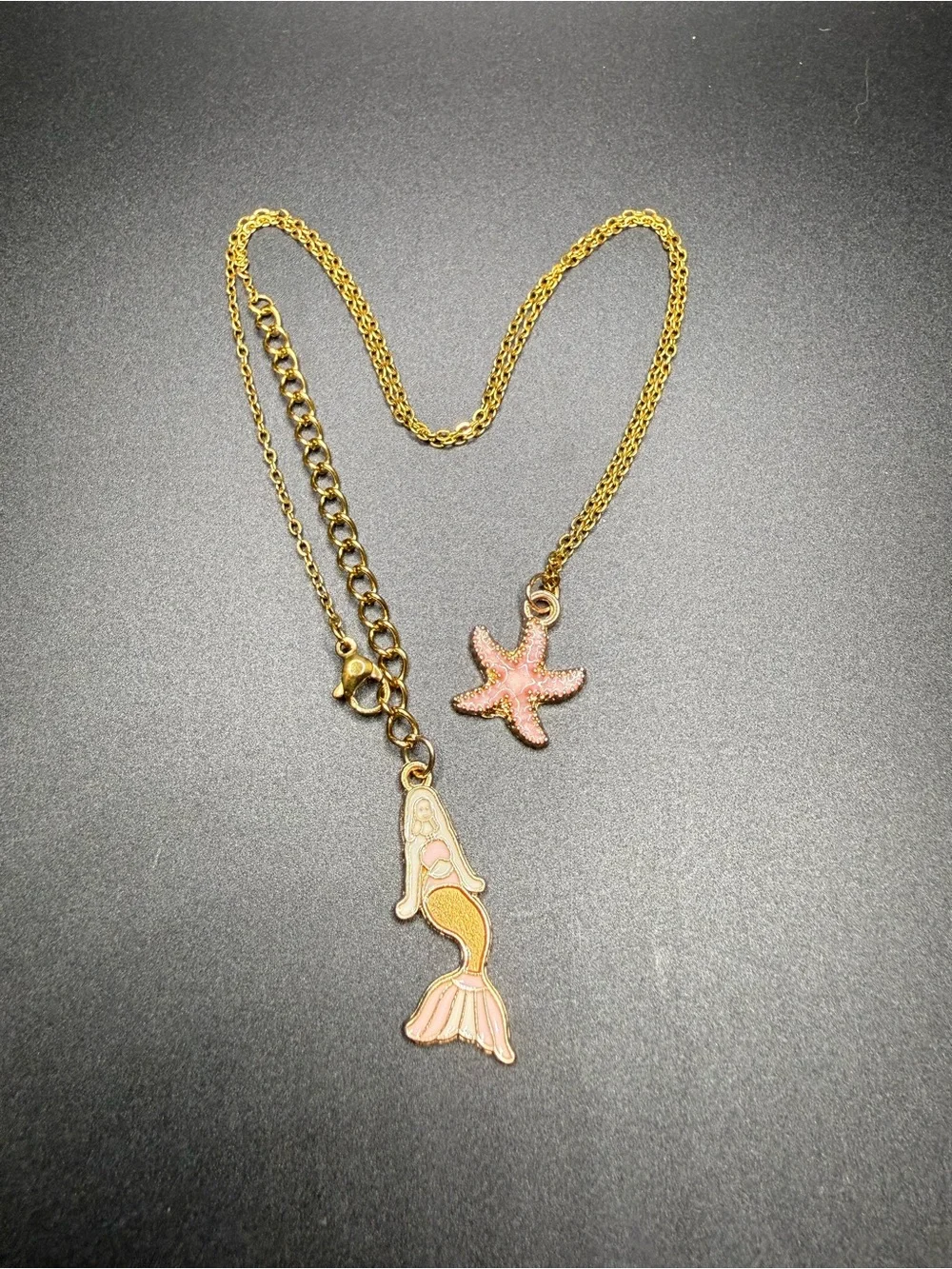 Gold tone Starfish Pendant Necklace with Pink Enamel mermaid in the back.